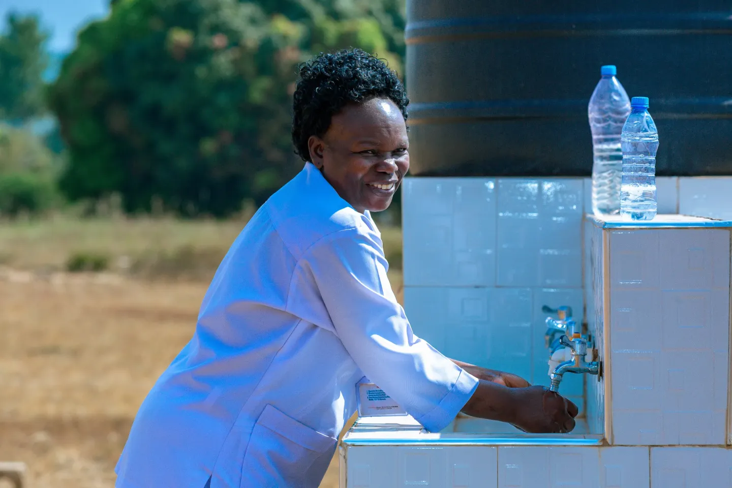 Nurse Aloysia Bakuza washes her hands using water from a UNICEF- and Republic of Korea-supported system at Biharamulo Hospital.