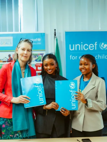 Abigail Chams signs her appointment as UNICEF Tanzania National Ambassador.