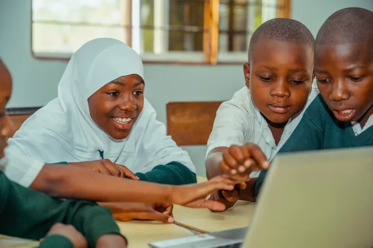 Student learning on her computer next to classmates