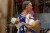 With both hands full, Salome moves through the market 