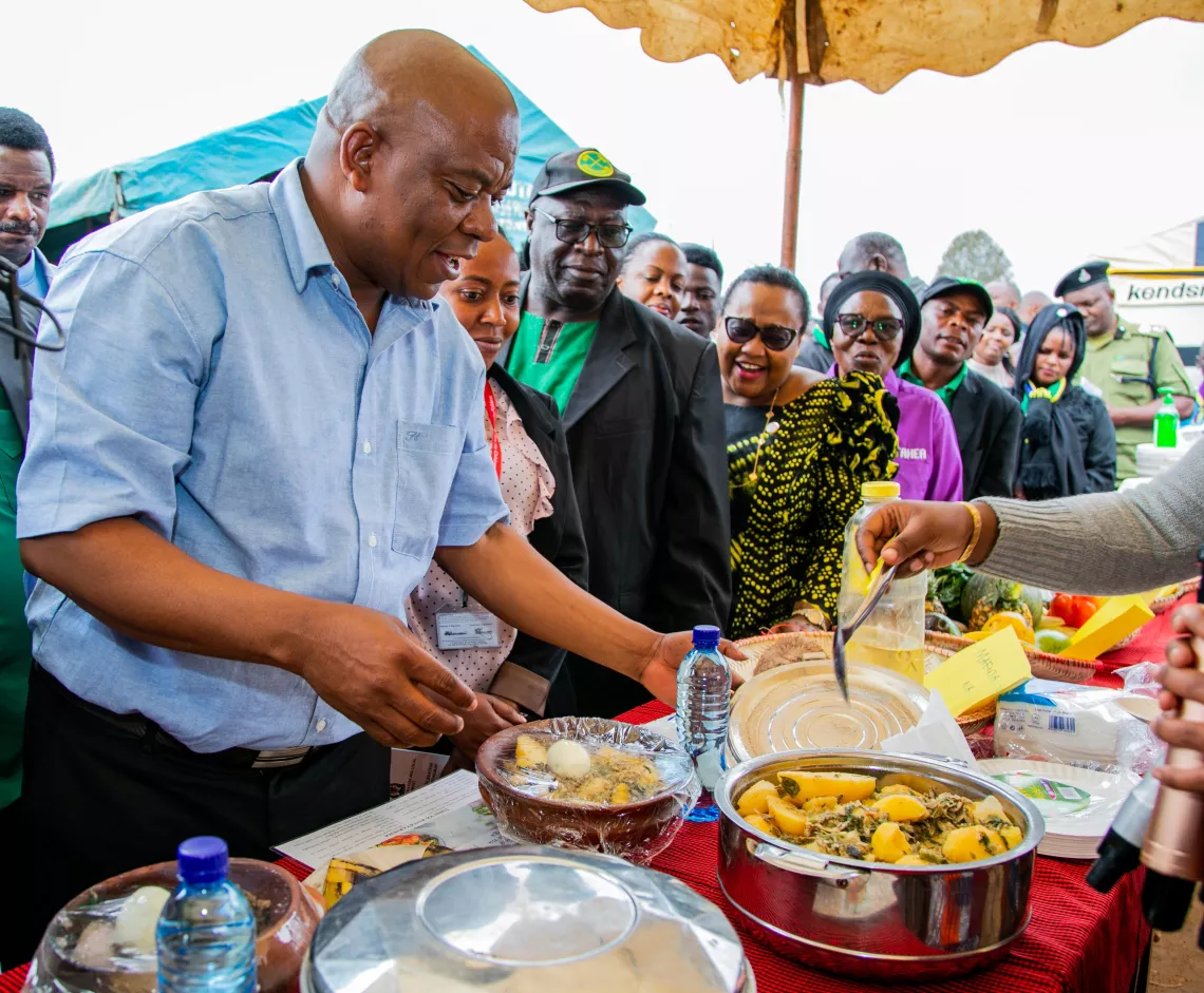 Honourable Anthony Mtaka, Regional Comissioner of the Njombe Region, enjoying a nutritious meal at the launch of the nutrition campaign to combat stunting  