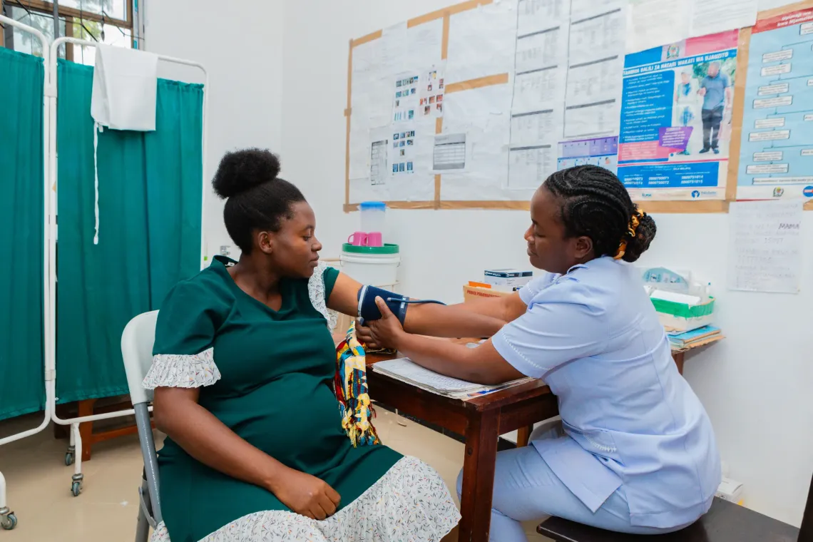 Ray Kimeme at her local health facility in Kishapu District, where she is receiving antenatal care during her second pregnancy. With reliable solar-powered electricity, the facility is now equipped to provide safe, consistent care.
