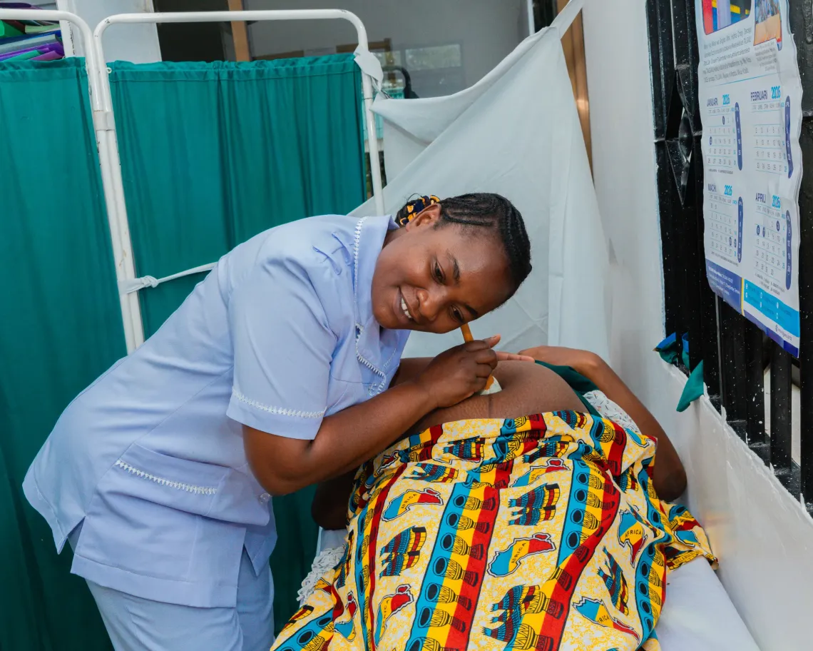 Ray David Kimeme at her local health facility in Kishapu District, where she is receiving antenatal care during her second pregnancy. With reliable solar-powered electricity, the facility is now equipped to provide safe, consistent care.