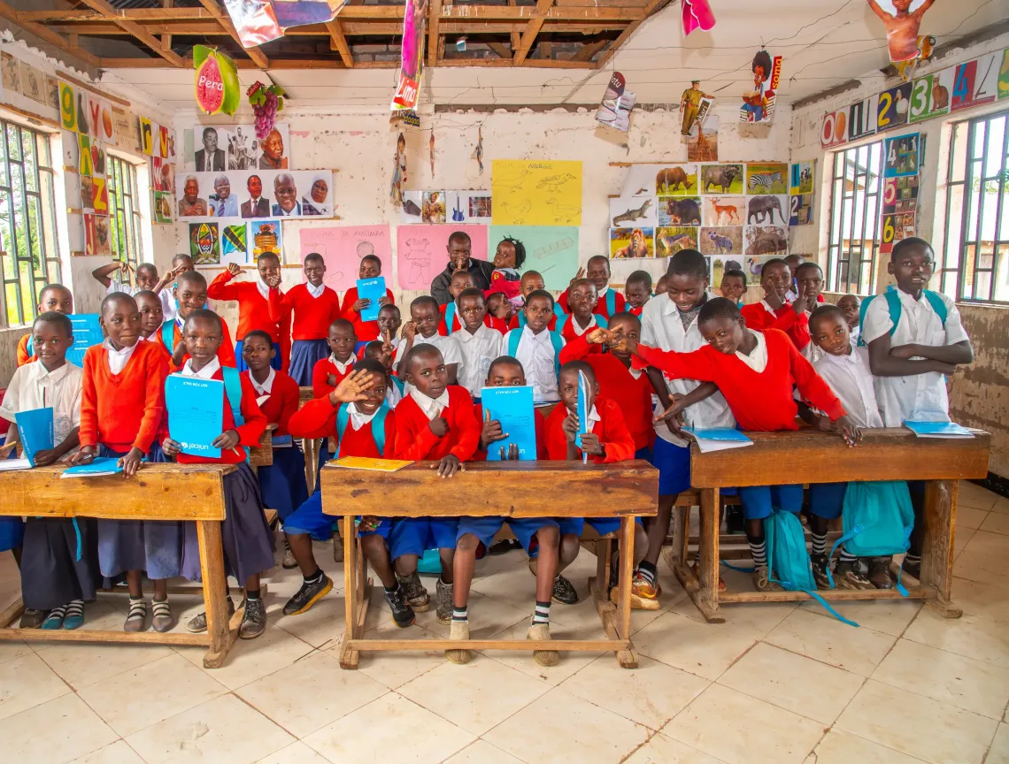 Thumbs ups, peace signs and all smiles, COBET class of Nyenjele Primary School.