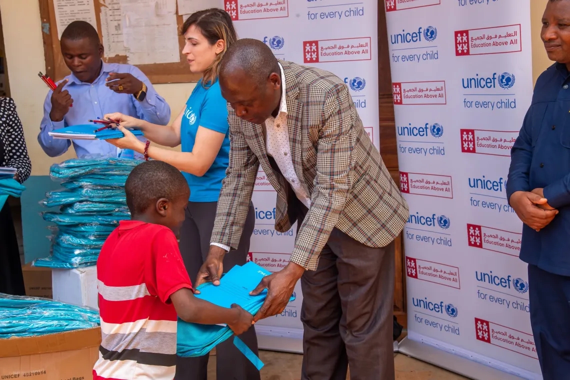 COBET Students receiving their learning materials through support from the Qatar Fund for Development through the Education Above All Foundation.