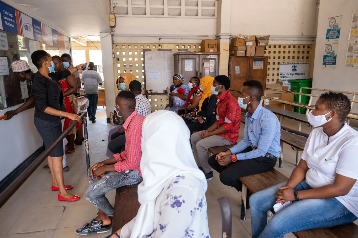 People are seated on benches during an awareness raising session