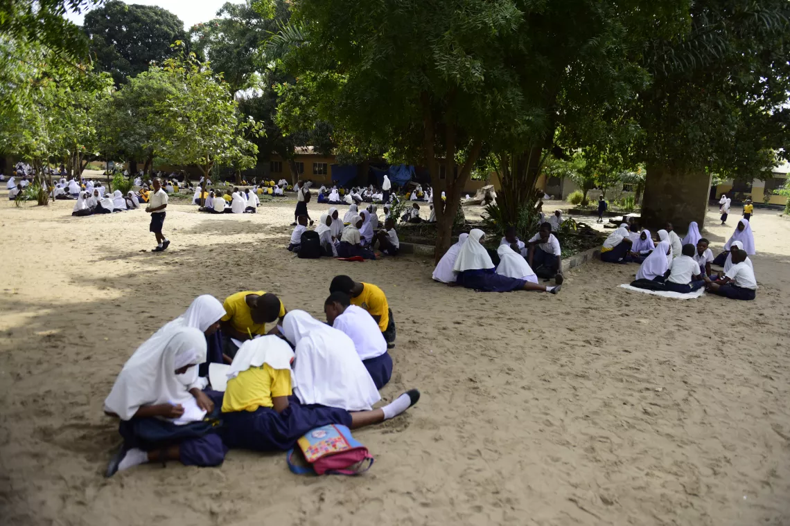 Children sitting outside school