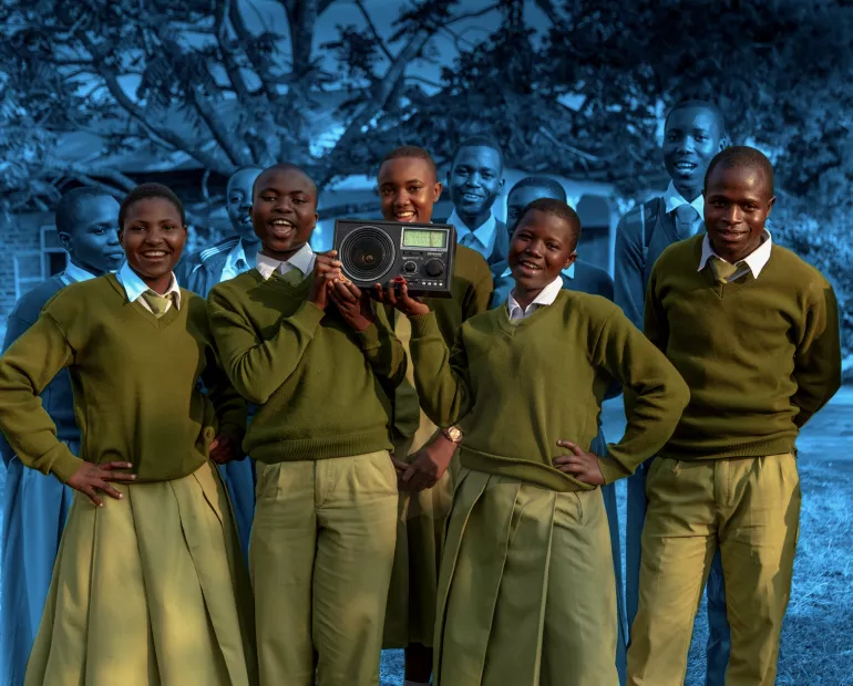 Young people holding a radio