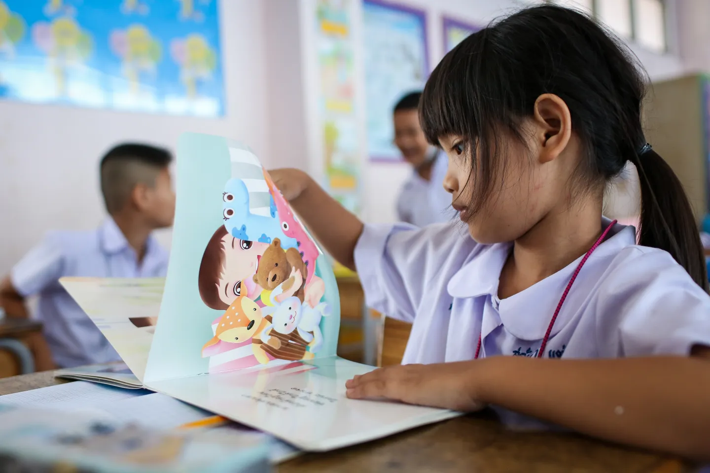 Young girl reading a picture book