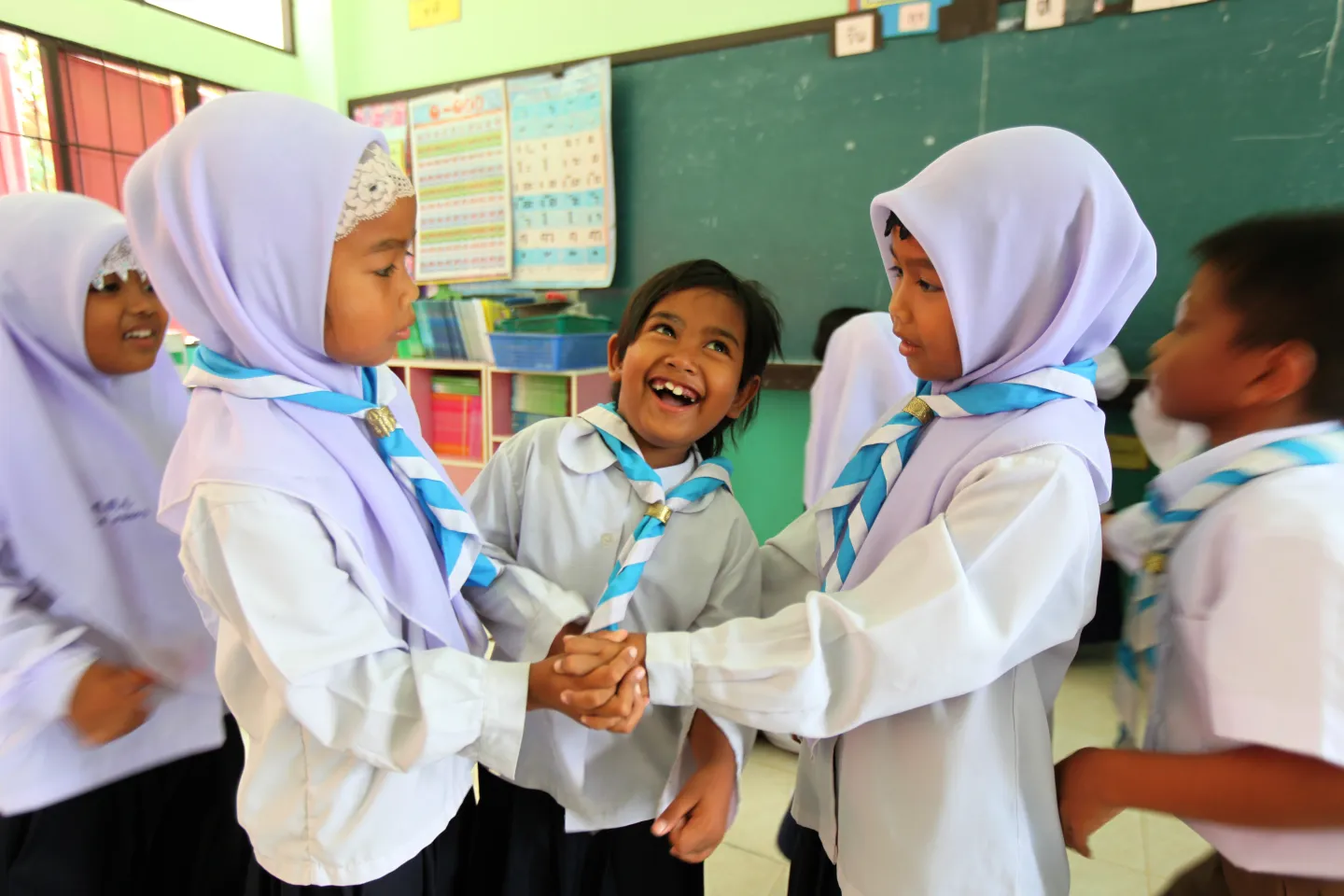 Students living in the far south of Thailand are playing happily in their classroom.