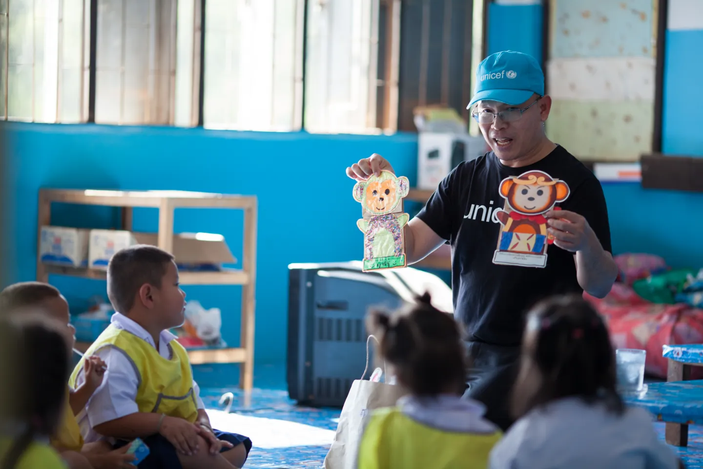 UNICEF officer is engaging with young children in a classroom