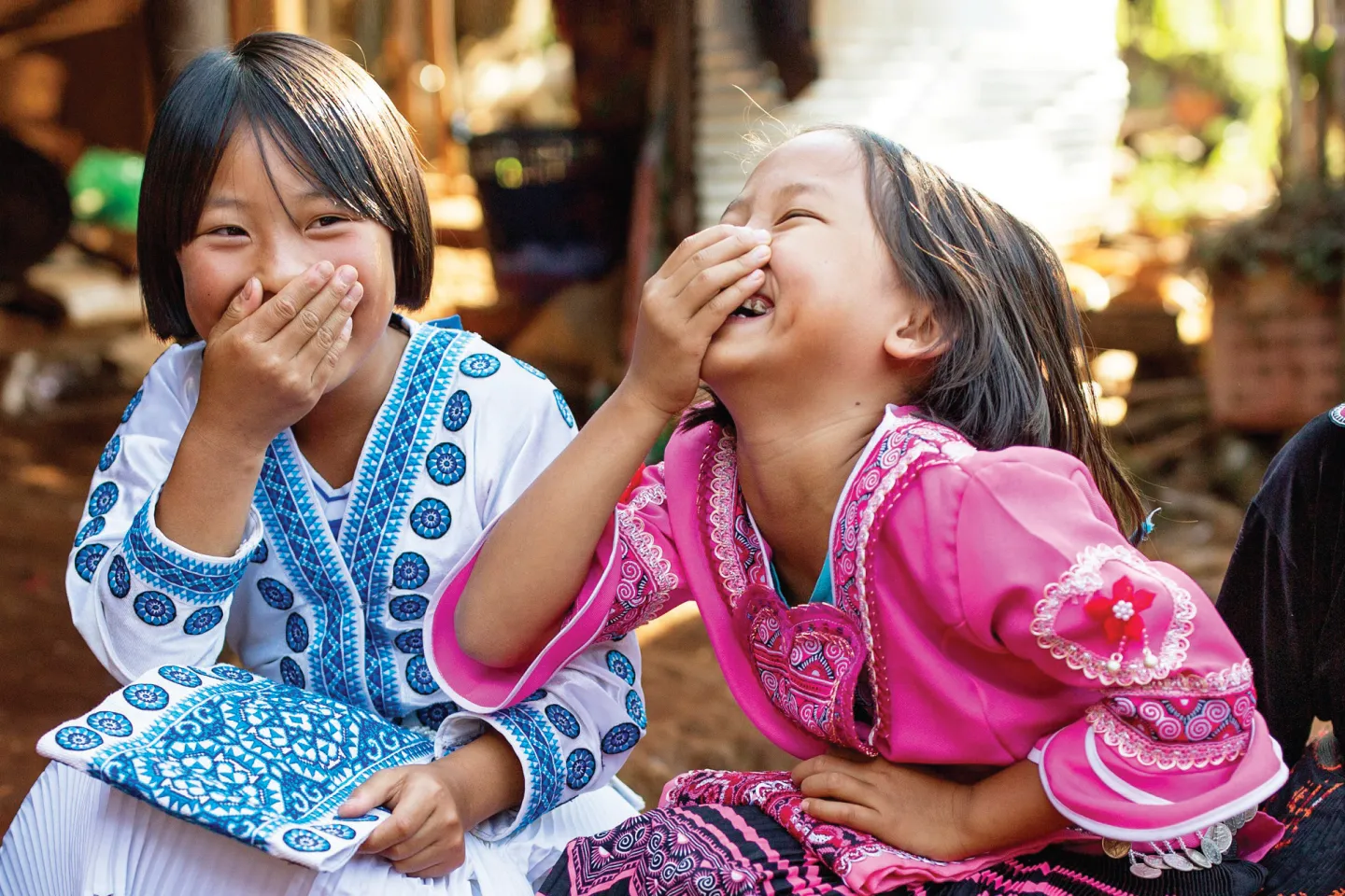 Two girls are sitting and laughing