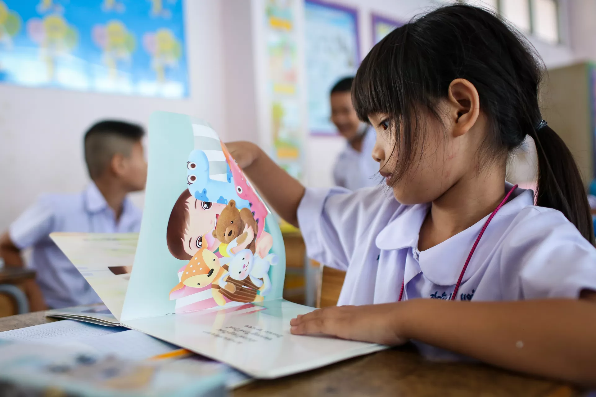 Young girl reading a picture book