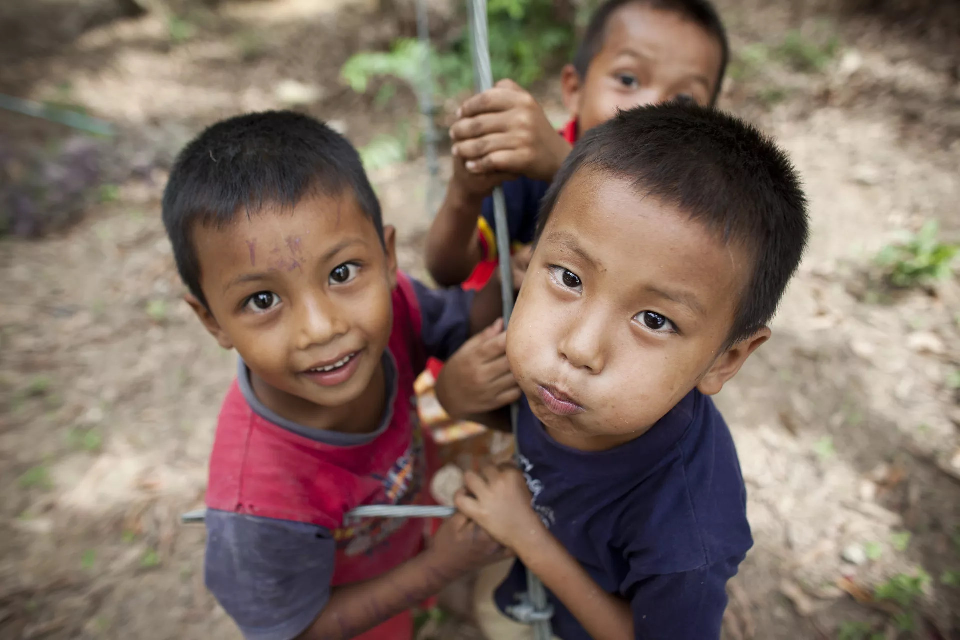 Three young boys are playing together.
