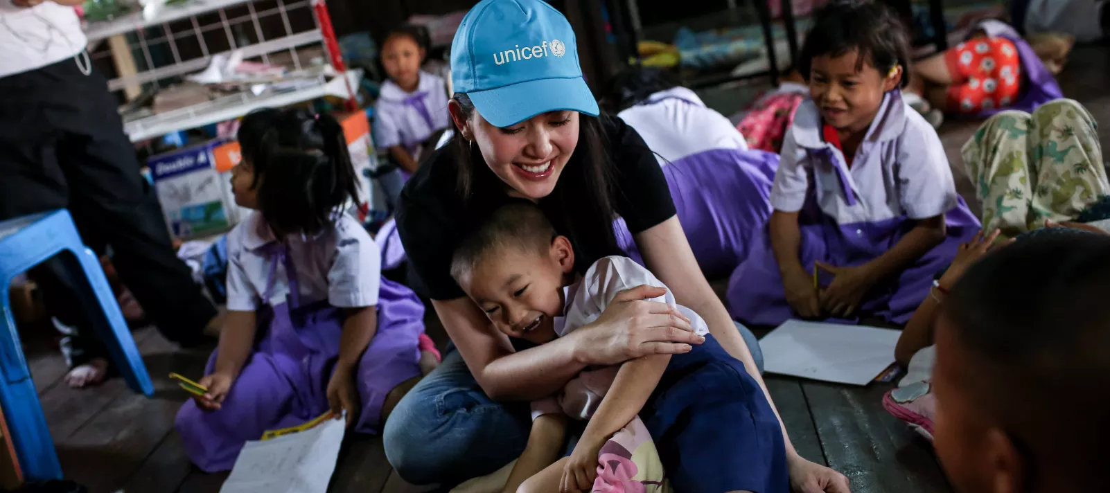 Mai Davika is engaging with a group of children during one her field visits