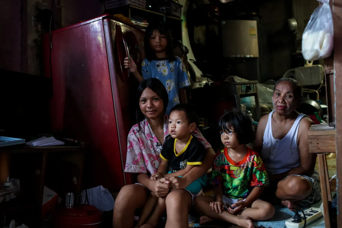 A grandmother and 4 children in their house.
