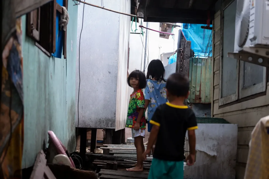 A girl standing in area nearby her house