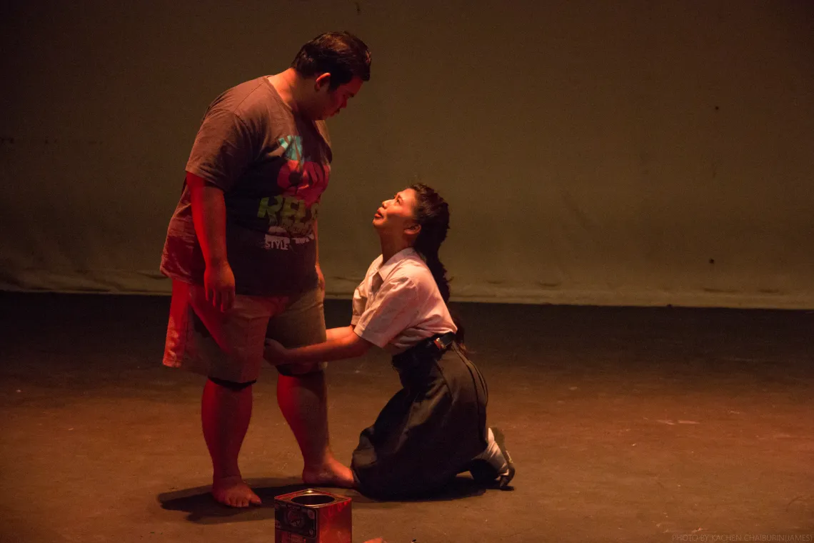 A young female student is begging a male adult.