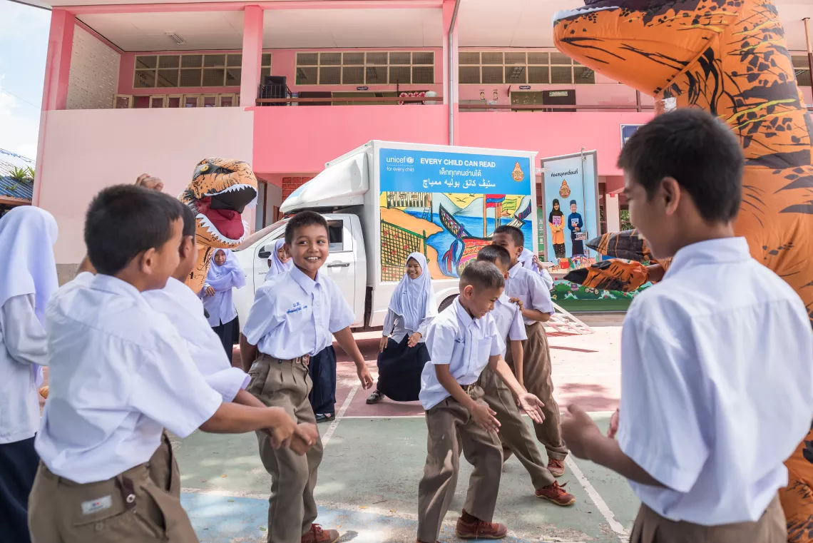 Children are playing around UNICEF&rsquo;s Mobile Library.