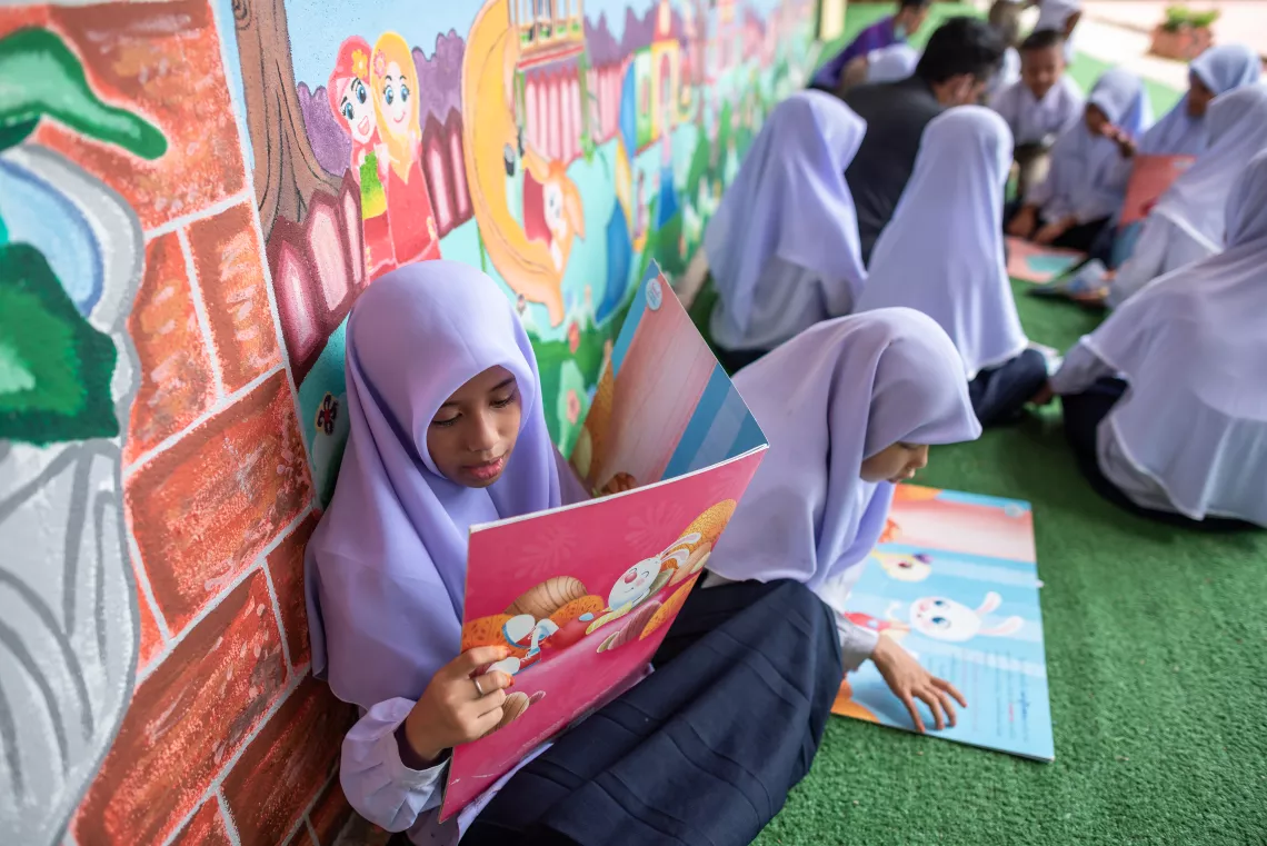 Students are reading books together.