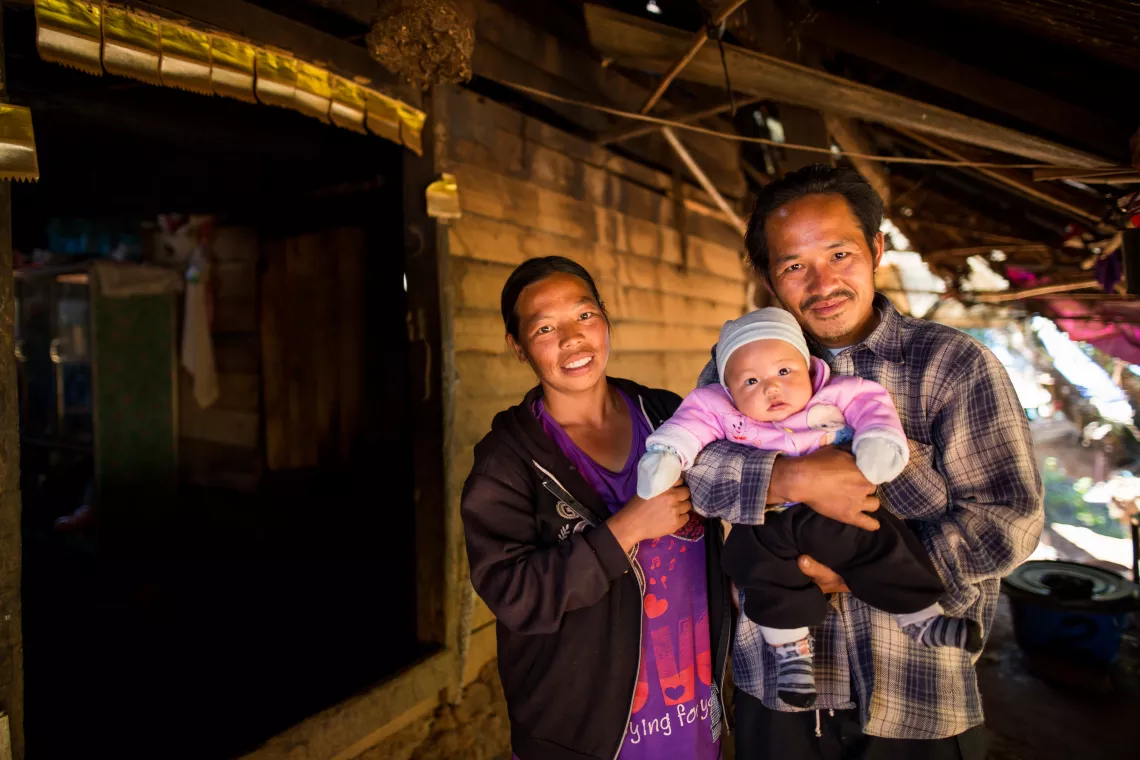 A family of a father, a mother, and a baby who benefit from the child support grant scheme