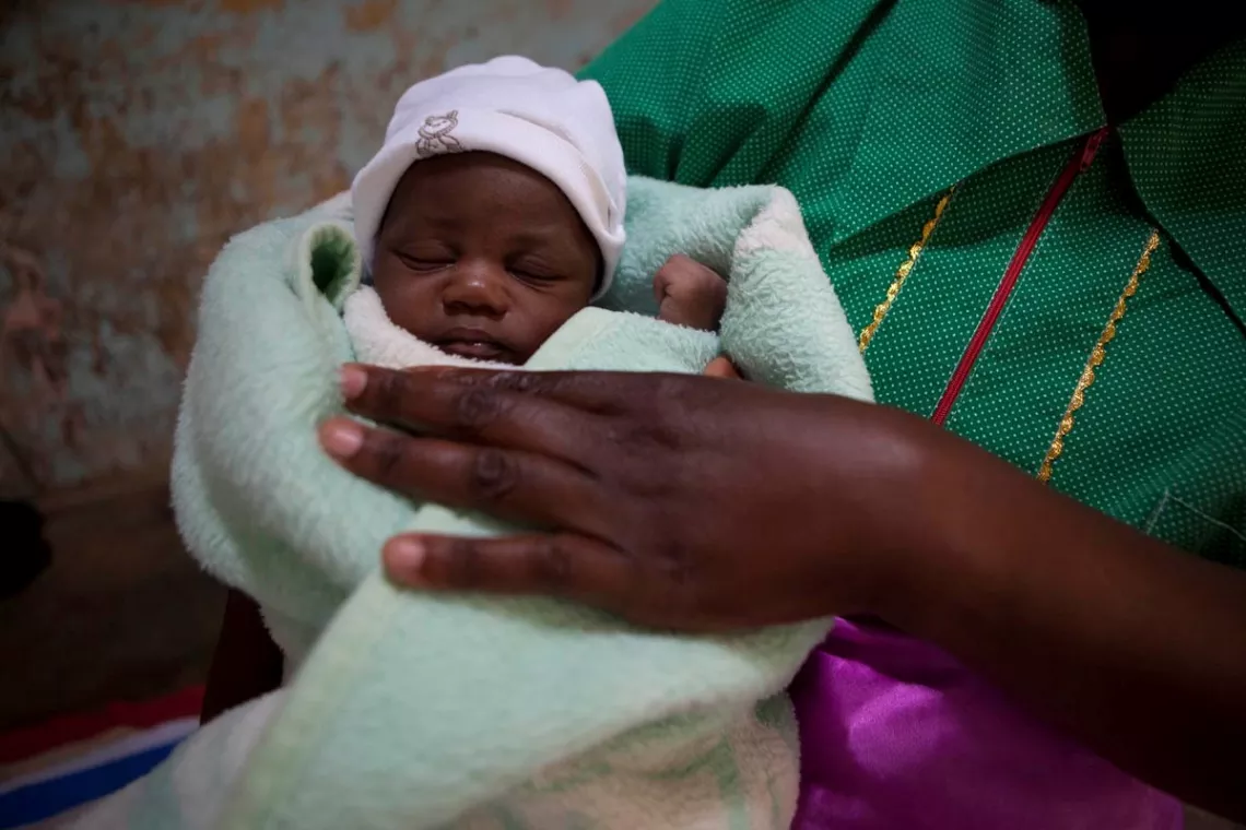 A baby in her mother's arms