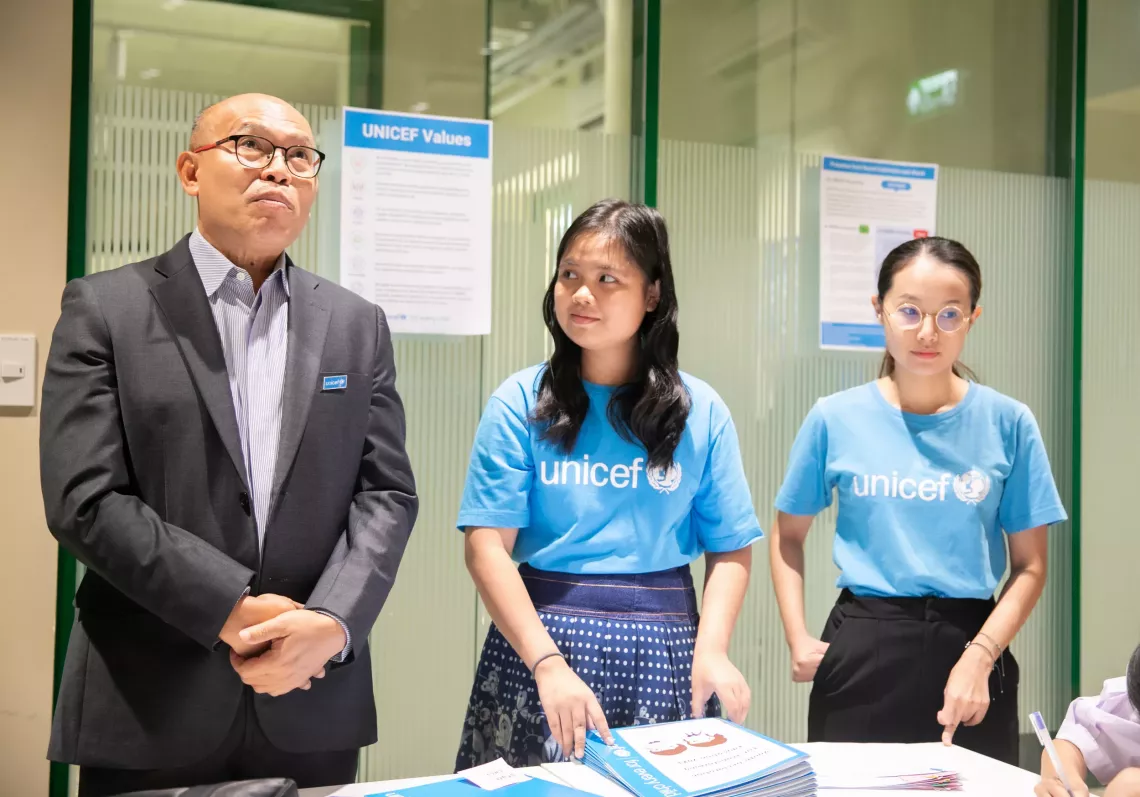 Nicha and UNICEF staff in a meeting room.