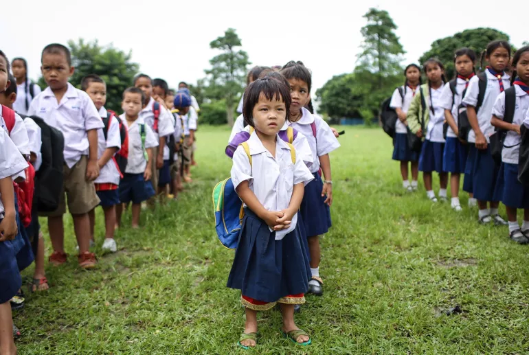 Migrant Student standing in the field 