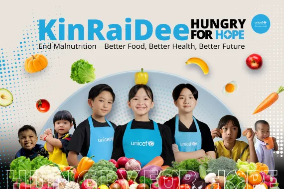 Children wearing UNICEF aprons stand smiling among colorful vegetables and fruits. Image contains text: "KinRaiDee Hungry for Hope &ndash; End Malnutrition: Better Food, Better Health, Better Future."