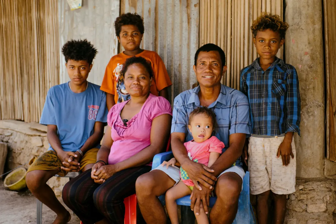 Marquita, Adriana and family outside the family home in Bulubai village