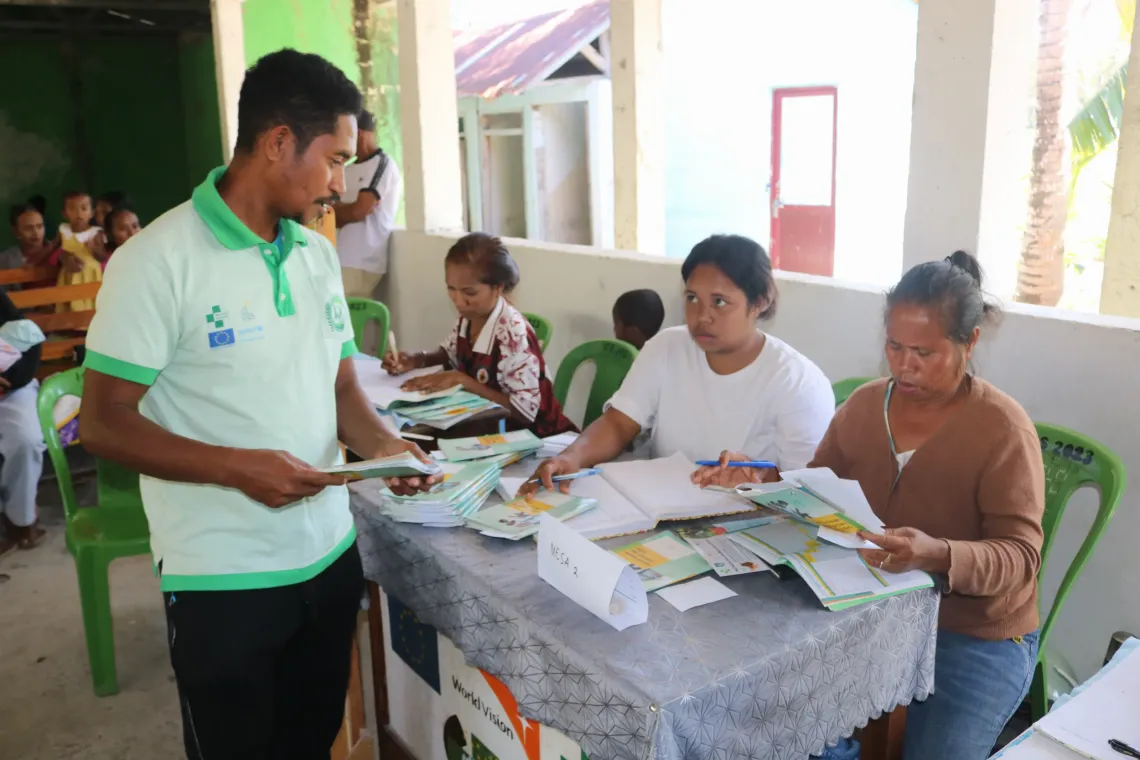 As an MSG member in Baha-Mori, Julio measures children aged five years and below and coordinates with health professionals to ensure each child's handbook is filled in correctly.