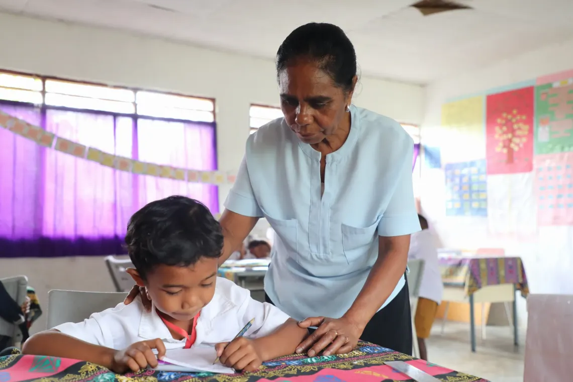 Aguida provides one-on-one support to a student during a learning session.