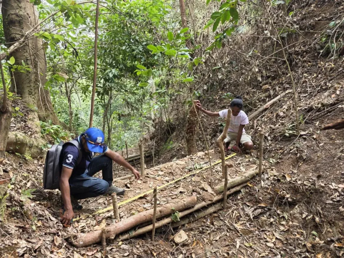 Etelvina, together with DNRAS, monitors a natural check dam constructed by the Tuileso community. 