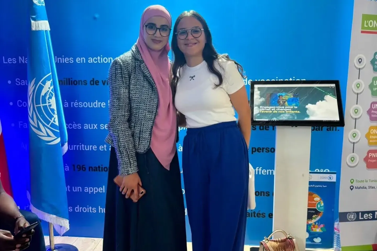 Yosr (left) and Farah (right) at the United Nations stand during the Tunis International Book Fair, promoting climate action.