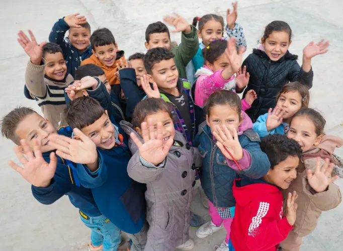 Children play and interact on their primary school grounds in Gaafour, Siliana, Tunisia, as part of their extracurricular activities.