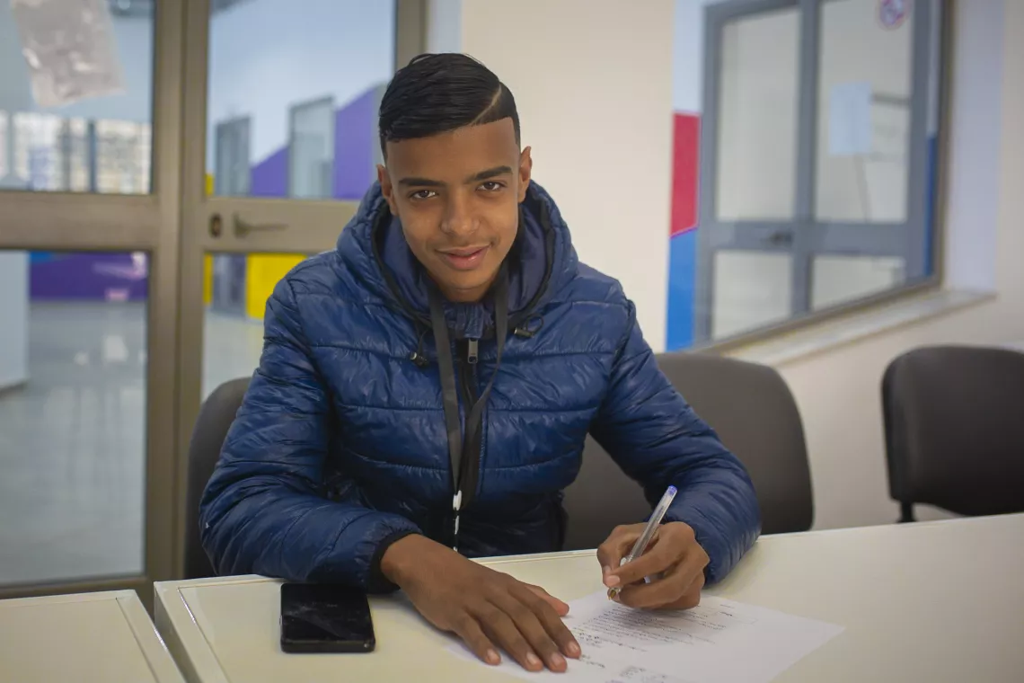 In a classroom a few teenagers complete an evaluation on their level of Arabic language. According to the aspirations and skills of each child, the social workers of the Center create a personalized plan./ Bab El Khadra, Tunis. 2021.