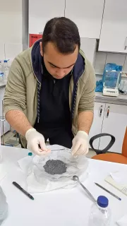 A member of Team Inspire works on a project in a science lab setting.