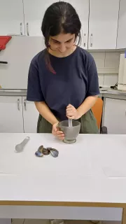 A member of Team Inspire works on a project in a science lab setting.