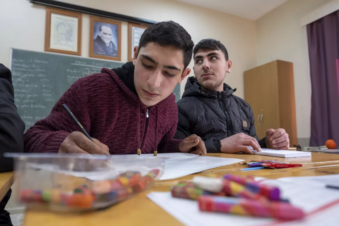 Gen&ccedil; bir lise &ouml;ğrencisi sınıfında yazı yazıyor. 