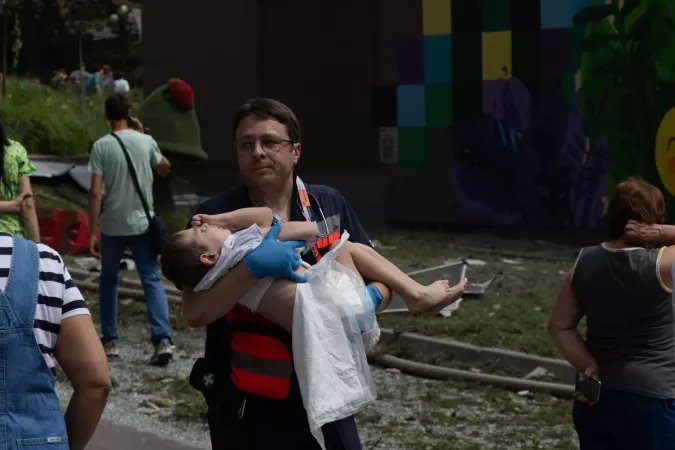 On 8 July 2024 in Kyiv, a rescue worker carries a child as first responders, hospital staff and volunteers clear the rubble and search for people trapped under debris after an attack that hit Okhmatdyt hospital, Ukraine's largest children's medical centre.