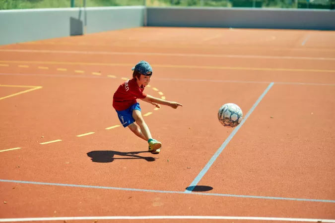 Child plays soccer.