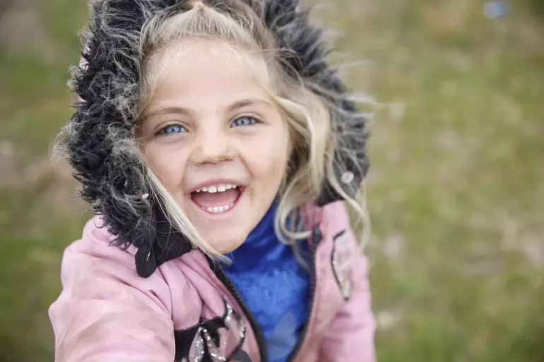 Girl smiles at camera. 