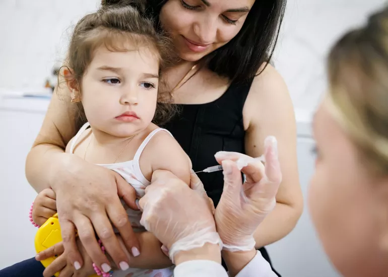 A girl receives a vaccine.