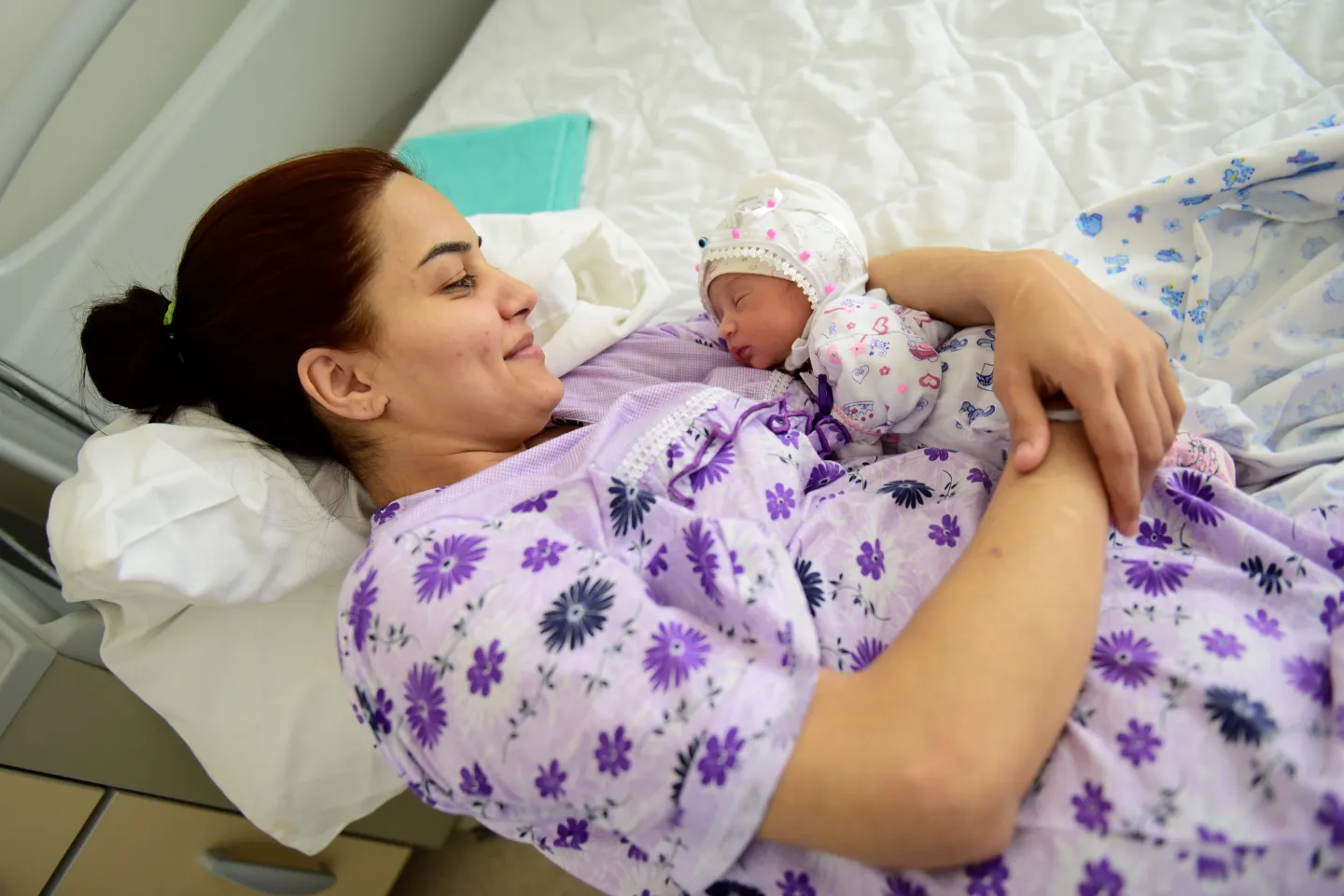 Mother breastfeeds her first born
