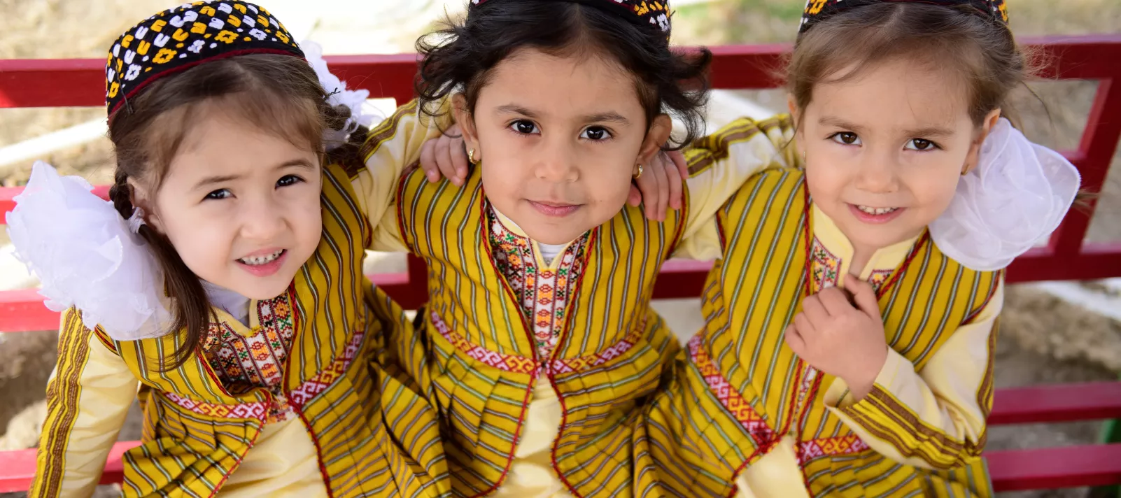 Three kindergarten children in national Turkmen clothing