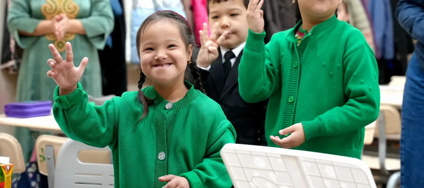 a photo of children smiling and looking at the camera