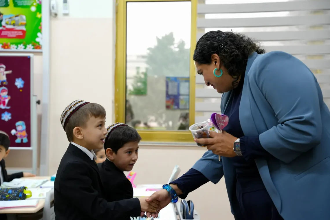 An adult interacting with a child