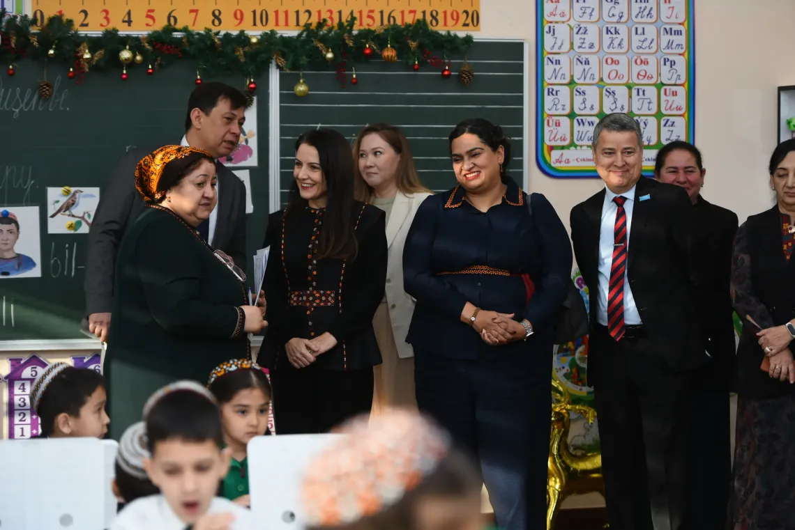 A group of people visiting a classroom with children