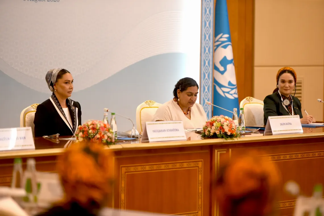 UNICEF Representative Ms. Jalpa Ratna speaking into a microphone while seated next to Ms. Oguljahan Atabayeva&nbsp; at the main panel table.