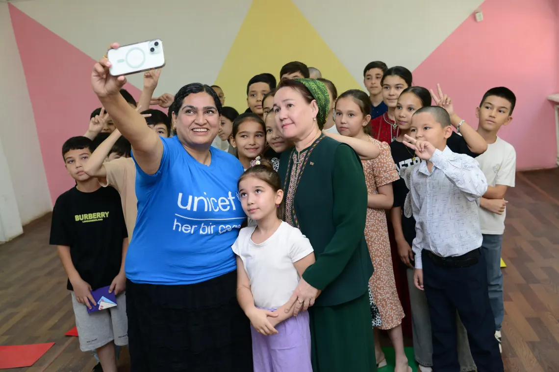 A woman taking selfie with children 